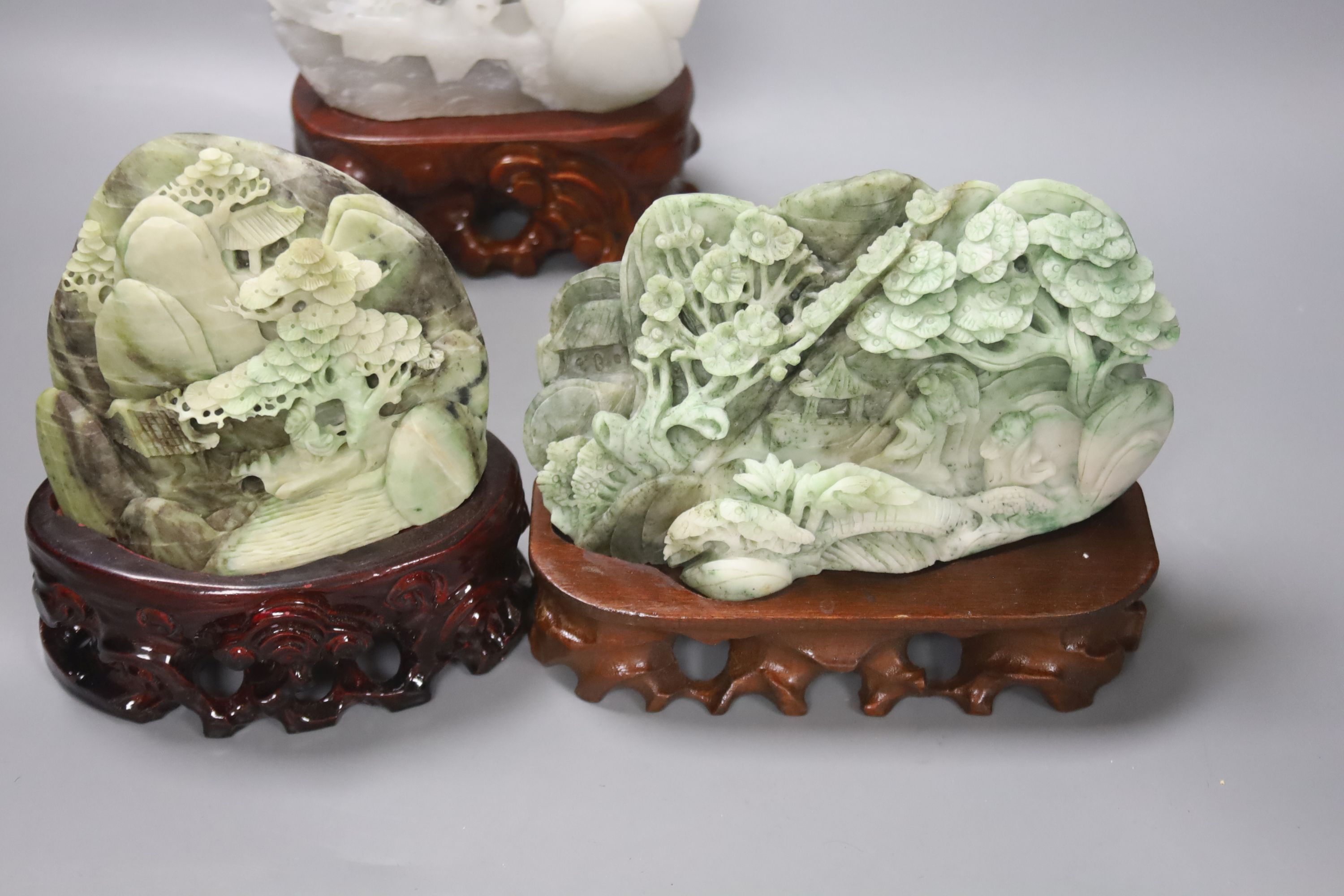 Five Chinese hardstone carvings on carved wooden bases, tallest 19cm, together with a carved hardstone libation cup, 8cm
